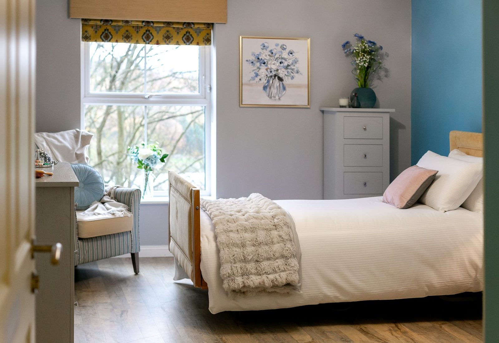 A bright, well-furnished care home bedroom